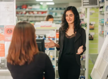 Pharmacist-behind-the-counter-talking-with-a-patient
