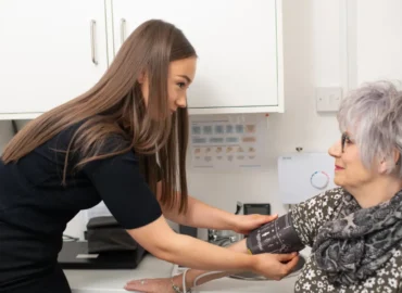Pharmacist-taking-blood-pressure-of-old-patient-1